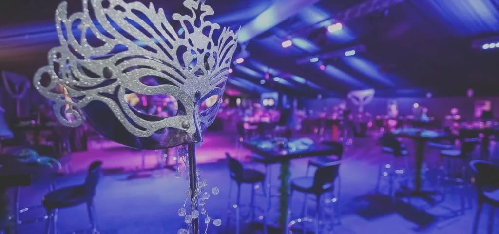 Masquerade themed gala event with purple lighting in Dubai