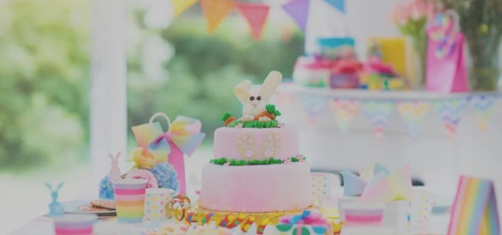 Colourful kids birthday party table with decorated cake and bunting