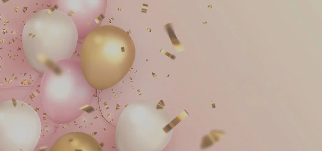 Elegant pink and gold celebration balloons with confetti